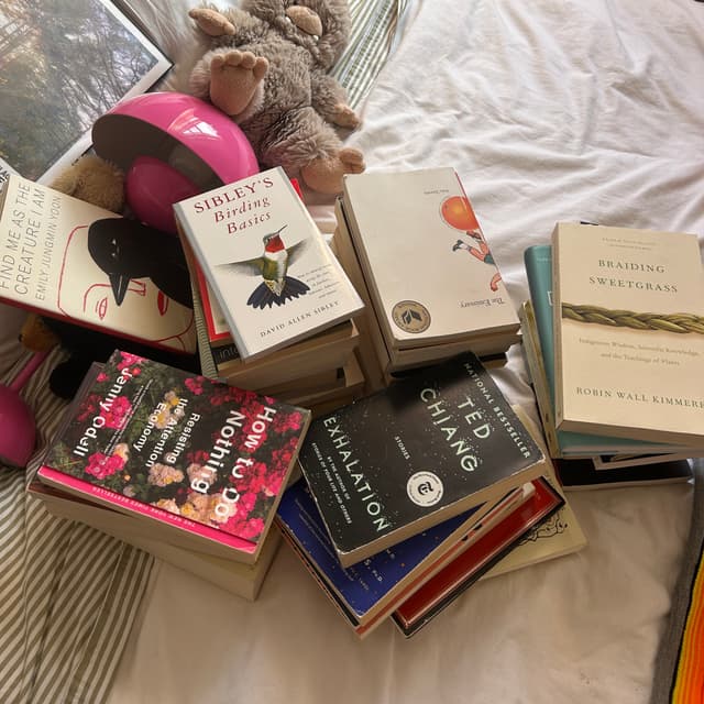 pile of my books on bed
